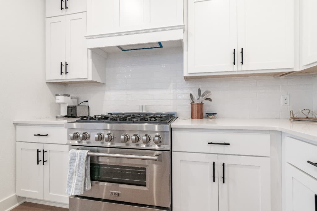Jenkins Avenue — professional gas range and white cabinetry