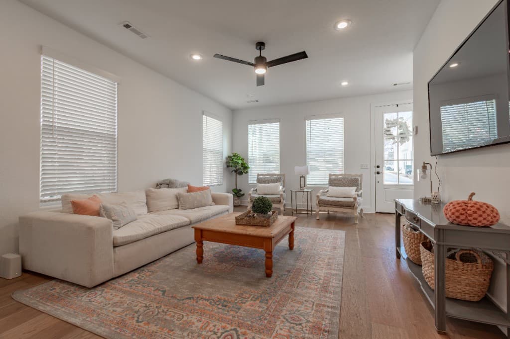 Jenkins Avenue — living room with sofa, patterned rug, and windows